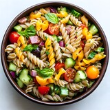 A vibrant and delicious pasta salad brimming with fresh vegetables, herbs, and cheese in a rustic bowl.
