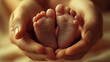 © manapaund - Two adult hands gently cradling two tiny newborn baby feet, conveying a tender and loving emotion