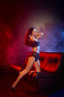 © LIGHTFIELD STUDIOS - Elegant woman showcasing allure and confidence in a dramatic, colorful lighting environment