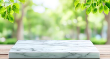 Poster - Marble tabletop on wooden surface with green leafy branches and blurred outdoor park background, bathed in natural daylight.