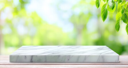Poster - Marble platform on a wooden table with green leaves and blurred nature background.
