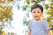 © Treechada - Happy little boy playing at park. Nature background. Concept of happiness. Copy space.