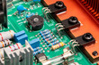 © Pituk - Close up, electronic circuit board, transistors, resistors, capacitors, and diodes on the printed of an amplifier circuit board