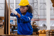 © unikyluckk - African american engineer woman wearing safety helmet and vest working with card box in paper warehouse Products and corrugated cardboard Factory female worker in the manufacture of paper