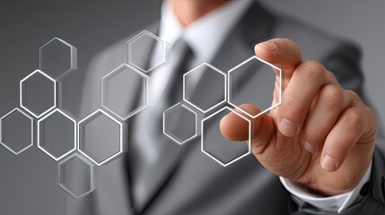 Poster - A businessman touches a digital screen displaying hexagonal patterns, illustrating advanced business technology concepts in action
