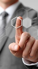 Poster - A businessman touches a digital screen displaying hexagonal patterns, illustrating advanced business technology concepts in action