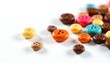 © Muzamilart - colorful chocolate buttons on a white background