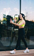 © BullRun - Content athletic woman making video call on street