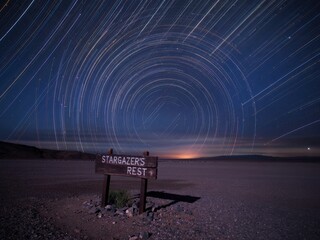 vibrant long exposure capture of celestial trails above stargazer's rest under a night sky
