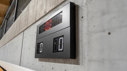 Aufkleber - A closeup of a sleek energyefficient scoreboard with a minimalist design focusing on the texture and finish against the rough concrete wall of a sports arena under renovation.