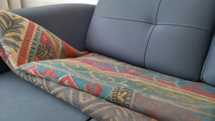 Poster - A closeup of a wornout colorful textile being unraveled as its rep with a modern durable fabric for upholstered seating highlighting an upgrade in comfort.