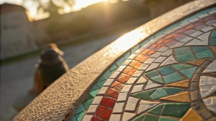 Poster - A medium closeup capturing the detailed craftsmanship of a mosaic tile being adjusted into place with sunlight glinting off its glossy surface and tiny shards of glass reflecting