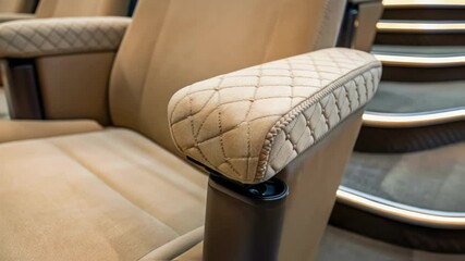 Aufkleber - Closeup of a cushioned armrest being fitted onto a theater seat with the texture and stitching in sharp focus.