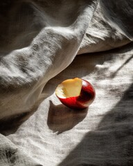 Poster - Bitten red apple on linen fabric in natural light a still life composition capturing simplicity and organic textures with a focus on healthy eating and rustic charm