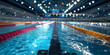 © ALSADRA - Close-up view of water lanes in indoor swimming pool under bright lights, ideal for sports training, competition visuals and aquatic fitness concepts
