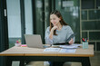 © PSG - Happy Young Businesswoman on Phone Call in Modern Office
