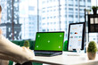 © DC Studio - Business director working in her own office with green screen, looking at device display and developing a new project idea. Female entrepreneur empowered by corporate culture.