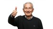 © Mateus - Content senior man on an isolated white background wearing a knit sweater giving a thumbs-up and smiling with a positive, confident expression.