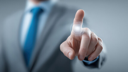 A man in a suit is pointing at a button on a screen