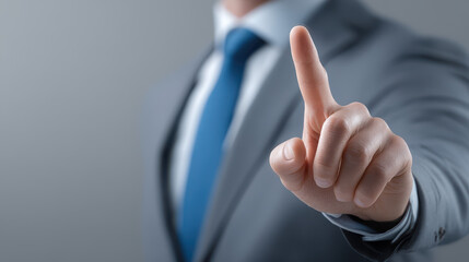 A man in a suit is pointing at a button on a screen