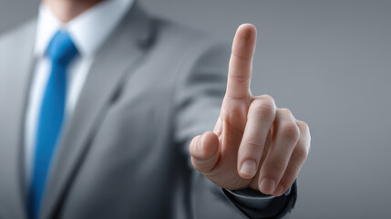 A man in a suit is pointing at a button on a screen