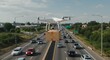 © Ulfiatul Savira - A drone carrying a package flying over traffic.