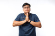 © ArvStd - Young asian doctor man over isolated background begging and praying with hands together with hope expression on face very emotional and worried. Asking for forgiveness. Religion concept.