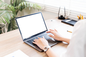 Fototapete - Cropped shot of woman hand working on laptop computer and peper work while sitting at the table..