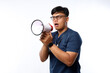 © ArvStd - Young Asian man doctor on white studio background speaking talking in loudspeaker. Make announcement in speaker. Medicine, attention, healthcare concept.Holding megaphone
