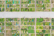 © Lawren Lu/Stocksy - Aerial View of Agricultural Plots Divided by Concrete Road