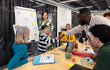 © VICTOR TORRES/Stocksy - Creative teamwork session with adults and child in modern office