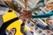 © VICTOR TORRES/Stocksy - Diverse team united by a motivational handshake in office setting