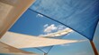 © Olena - Modern Terrace in Summer with Stylish Shade Sails Under a Bright Blue Sky