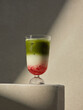 © Marc Tran/Stocksy - A delicious layered matcha latte with strawberry and milk