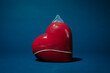 © Juan Moyano/Stocksy - condom covering a porcelain heart