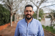 © Lupe Rodriguez/Stocksy - Portrait of a bearded young man on a city promenade