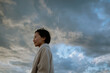 © JIE MA/Stocksy - A woman calmly facing a sudden change in weather.