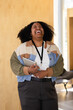 © VICTOR TORRES/Stocksy - Black woman joyfully laughing while embracing a digital tablet