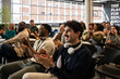 © VICTOR TORRES/Stocksy - Diverse audience applauding at a business seminar