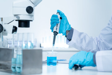 Wall Mural - asian researcher using a microscope in the clinical lab.male researcher working in the clinical labo