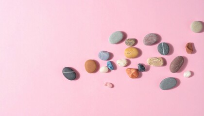 Poster - Colorful pebbles arrangement on pink background nature photography minimalist close-up beauty