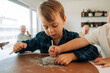 © Olga Moreira/Stocksy - Focused child playing with dig fossil kit