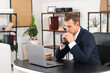 © Pixel-Shot - Thoughtful businessman working at desk in office