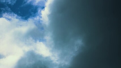 Wall Mural - Contrasting Clouds Timelapse of Storm Moving in Over Bright Blue Sunlit Sky. Natural Background Wallpaper Time Lapse.