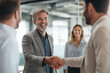 © Tatiana - Group of business professionals shaking hands in an office