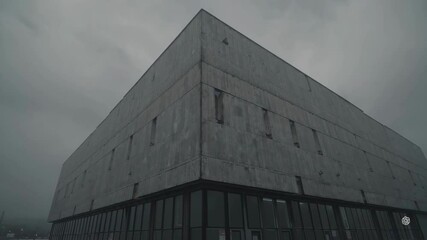 Poster - Foggy Atmosphere Surrounds Brutalist Factory Architecture in Urban Scene