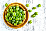 Green Organic Berries Gooseberries.Green gooseberries in a wooden bowl.Gooseberries on the wooden table. Harvest concept. Vegetarian food.