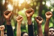 © Dhoku  Studio - Raised Fists in Unity Against a Blurred Green Background