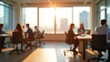 © Ulul Albab LM Putra - Open office with professionals working at desks, golden sunlight through windows, collaborative business environment with modern interior and soft blurred background