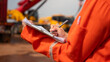 © Nattawit - An engineer or foreman is checking on safety checklist form of lifting crane at the drilling rig work site. Industrial safe working concent, close-up and selective focus.
